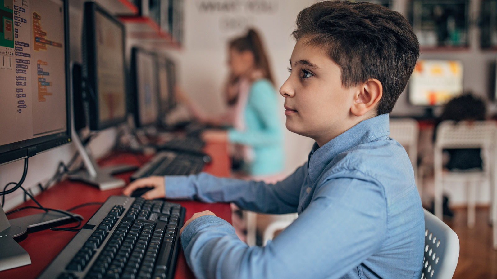 Middle school student working on computer at school